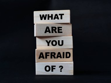 What are you afraid of, quote text written on wooden block, motivation inspiration concept clipart