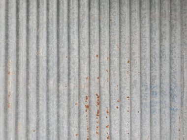 Paslı galvanizli, kıvrımlı, gri renkli metal levhanın desenli arka planı