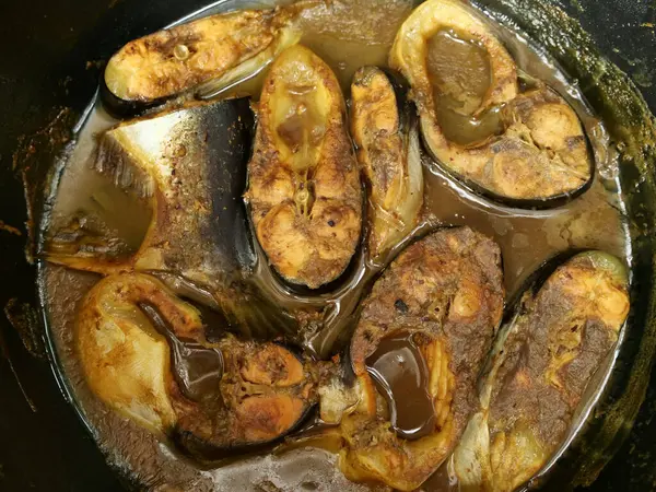 stock image Cooking fish curry, gulai or pindang ikan patin. Delicious Asian dish. Boiling in cauldron