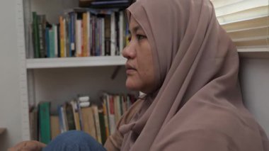 Üzgün, yalnız, Asyalı Müslüman kadın boş boş düşünüyor, hayal kırıklığı içinde, depresif biri.