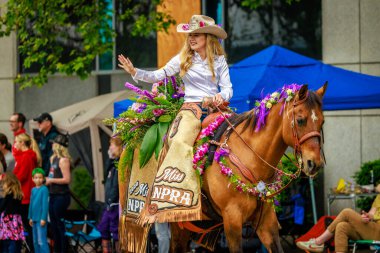 Portland, Oregon, USA - June 11, 2022: Miss Northwest Professional Rodeo Association, Zoe Brooks, in the Grand Floral Parade, during Portland Rose Festival 2022.