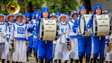 Portland, Oregon, USA - June 11, 2022: Falun Dafa Tian Guo Marching Band in the Grand Floral Parade, during Portland Rose Festival 2022.