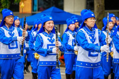 Portland, Oregon, USA - June 11, 2022: Falun Dafa Tian Guo Marching Band in the Grand Floral Parade, during Portland Rose Festival 2022.