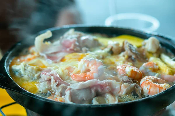 stock image Shrimp on hot black pan with oil and butter to cook grilled bbq on a hot stove. Holiday eating at a restaurant.