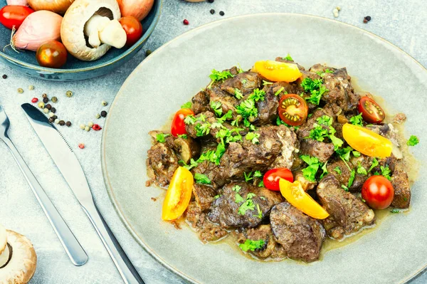 stock image Chicken liver roasted with mushrooms and tomatoes. Liver in Georgian