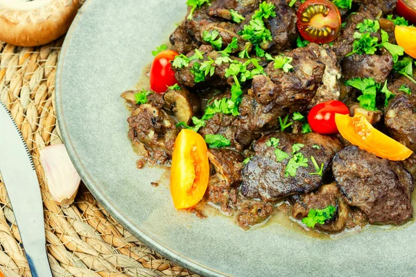 Chicken liver roasted with mushrooms and tomatoes. Liver in Georgian