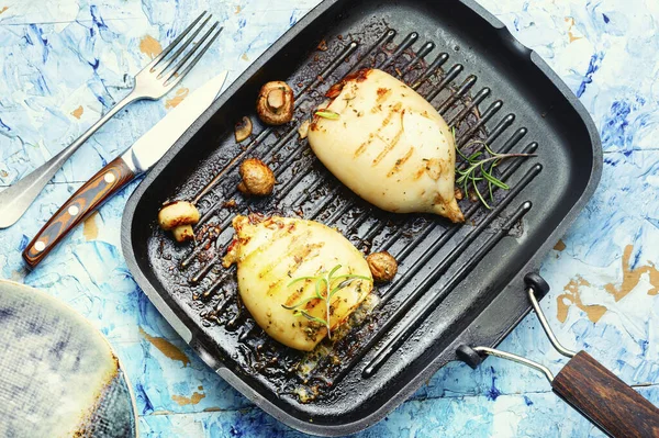 Grilled squids with vegetable stuffing. Stuffed calamari in grill pan