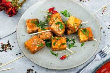 Grilled tofu cheese skewers on the plate. Healthy food clipart