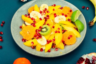 Vitamin fresh salad of mango, citrus, banana and berries. Healthy diet.