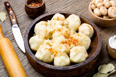Knedliks, a boiled product made from dough, potatoes with mushroom filling on rustic the table