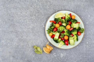 Colorful salad with broccoli, tomato, cucumber and physalis. Healthy food concept. Copy space