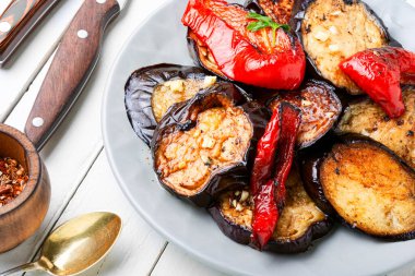 Prepared grilled eggplant slice and grilled bell pepper on a plate