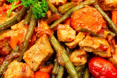 Stewed meat with carrots,tomatoes and french bean.Meat sauce, gravy with green beans. Close up,food background