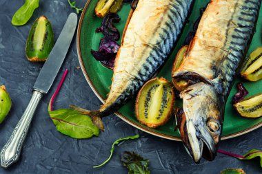 Two delicious scomber fish baked with kiwi pieces.