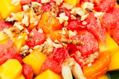Delicious vitamin salad of grapefruit, mango, walnuts and chicory. Close up