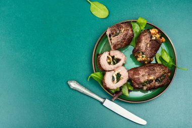 Beef meat rolls stuffed with mushrooms and herbs. Top view. Copy space