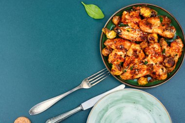 Delicious chicken wings with vegetables. Copy space