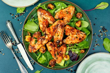 Baked chicken wings with vegetables. Poultry meat