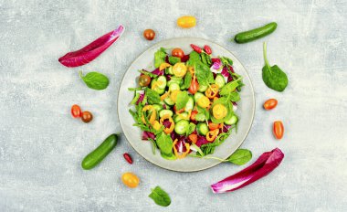 Spring salad of tomatoes, cucumbers, peppers and lettuce. Diet menu