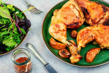 Tasty barbecue chicken drumstick and fresh green salad. Chicken legs quarters