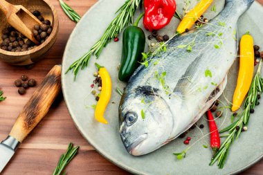 Çiğ dorado balığı ve baharat. Yemek pişirmek için malzemelerle birlikte.