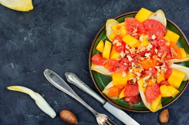 Freshly vitamin salad of grapefruit, mango and chicory. Copy space