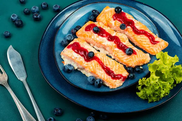 Fried tasty salmon fillet with blueberry berry sauce. Healthy food