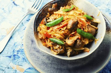 Mantar ve havuçla pişirilmiş lezzetli lahana. Yemeği ödünç al..