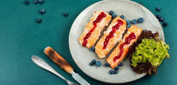 Fried salmon fillet with blueberry berry sauce. Healthy food. Space for text.