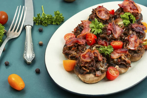 Appetizing champignon mushrooms filled with ground turkey,bacon.
