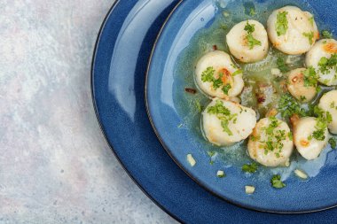 Kızarmış lezzetli deniz tarakları, yeşil tabakta.