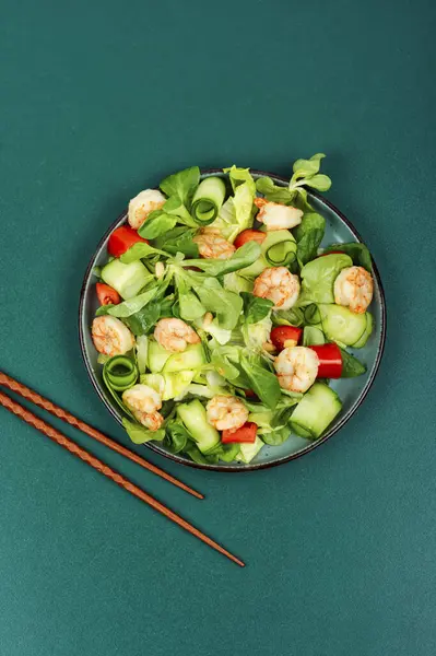 Plate with shrimps salad with green lettuce. Salad of shrimp or prawns. Healthy eating.