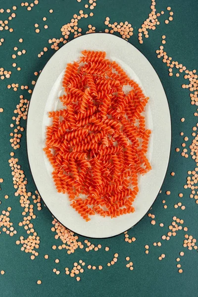 Uncooked Vegan Pasta Red Lentil Fusilli Plate — Stock Photo, Image