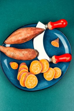 Sliced fresh sweet potatoes, orange kumara, yam. Healthy eating.