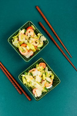 Asian salad with shrimps, prawns avocado, tomato.
