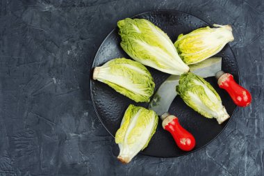 Fresh green Romaine lettuce. Mini romaine lettuce salad on kitchen table. clipart