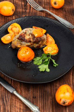 Mespilus Germanica meyveleriyle pişirilmiş iştah açıcı et. Karışık meyvelerle kızartılmış lezzetli et parçası.