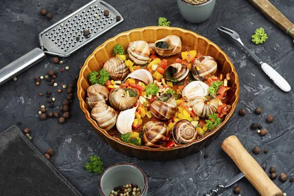 stock image Edible stuffed snails with butter and herbs.