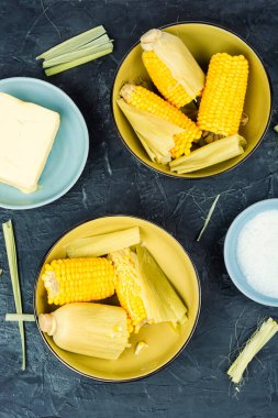 Boiled cob corn with butter and salt. Healthy meal, food snack diet on the table. Keto or paleo diet ,veggie or vegetarian. Top view. clipart