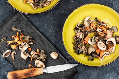 Beton mutfak masasında büyük bir aromatik kurutulmuş orman mantarı çeşidi. Üst görünüm.