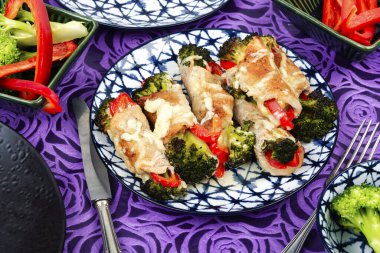 Delicious roll of meat or roulade with broccoli and bell pepper. clipart