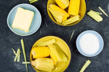 Homemade golden sweet corn cob with butter and salt. Flat lay clipart