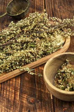 Wormwood herb or sagebrush herb on table. Medicinal healing herbs, herbal medicine or alternative medicine. clipart