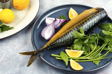 Plate of aromatic smoked mackerel or scomber fish. clipart