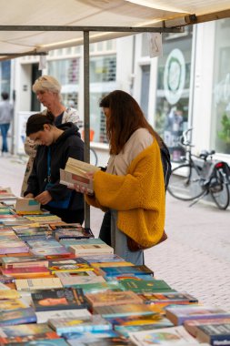 Dordrecht, Netherlands - July 7, 2024: Visitors explore second-hand books at the annual book market in Dordrecht, 350 stalls throughout the city centre, where booksellers offer their best books. clipart