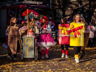 Dordrecht, Netherlands - November 17, 2018: Sinterklaas celebrations at Het Hof, children dressed as colourful presents, festive joy and Dutch traditions in a lively and heartwarming atmosphere. clipart