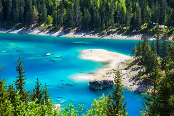 Small island in the middle of Cauma Lake (Caumasee) with crystal blue ...