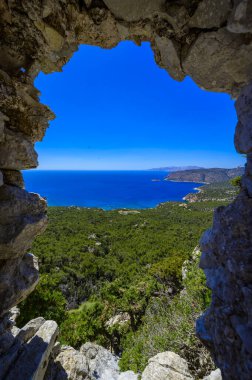 Monolithos Castle in paradise landscape scenery - travel destination on beautiful island Rhodes, Greece clipart