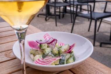 Colorful Cucumber Salad with Dill Dressing with a Glass of White Wine