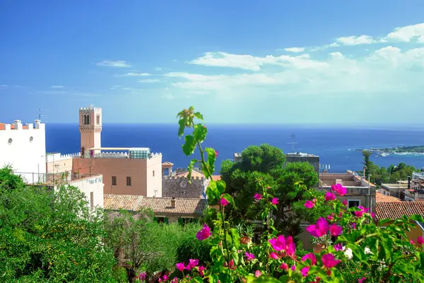 Photograph of houses in Taormina, Sicily, houses, trees, flowers during the summer in a sunny da